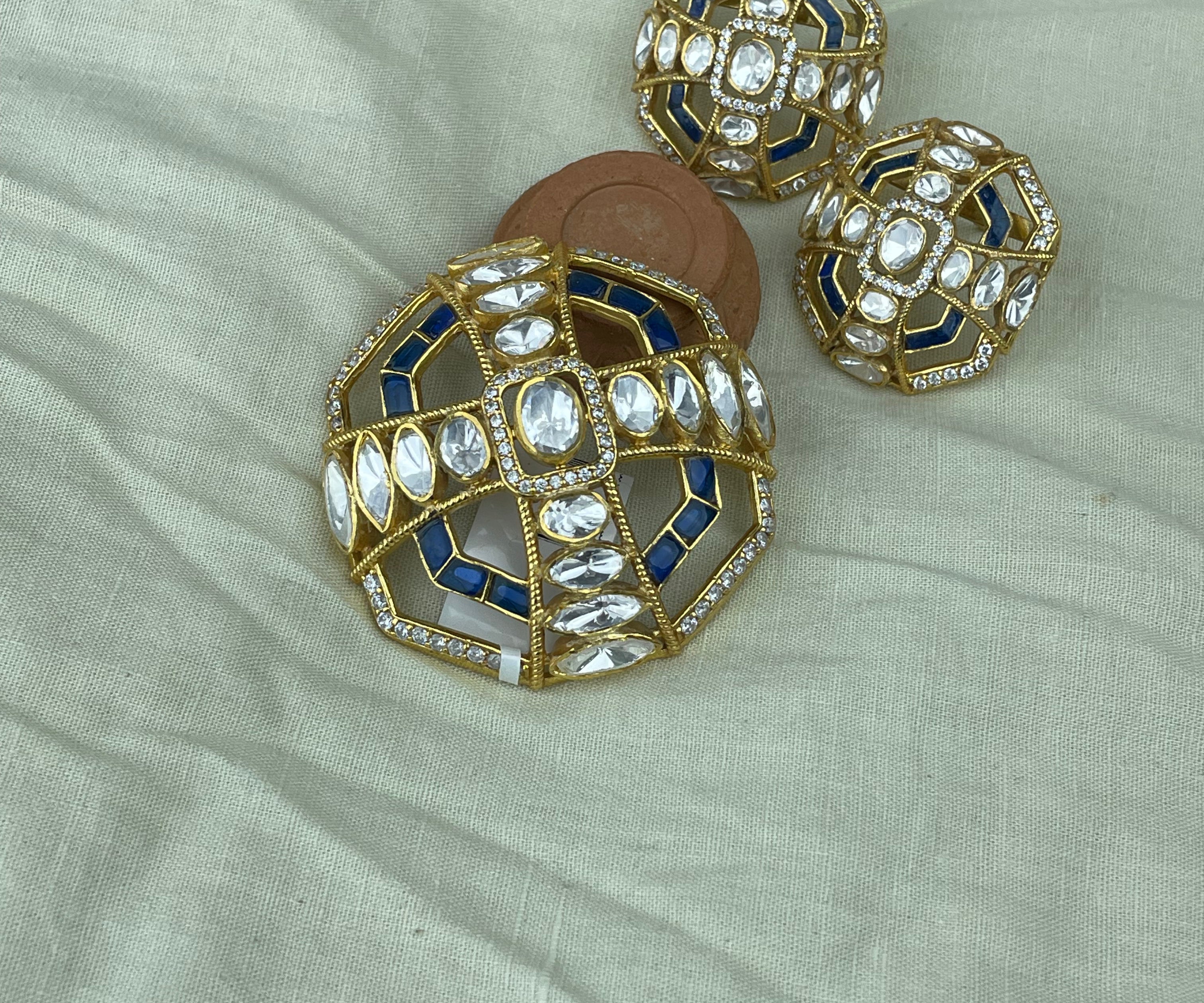 Neelambara Pendant Set with blue enamel, clear polki stones, and gold-toned geometric detailing.
