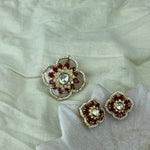 Pendant Set with matching a pair of gold-toned floral stud earrings.