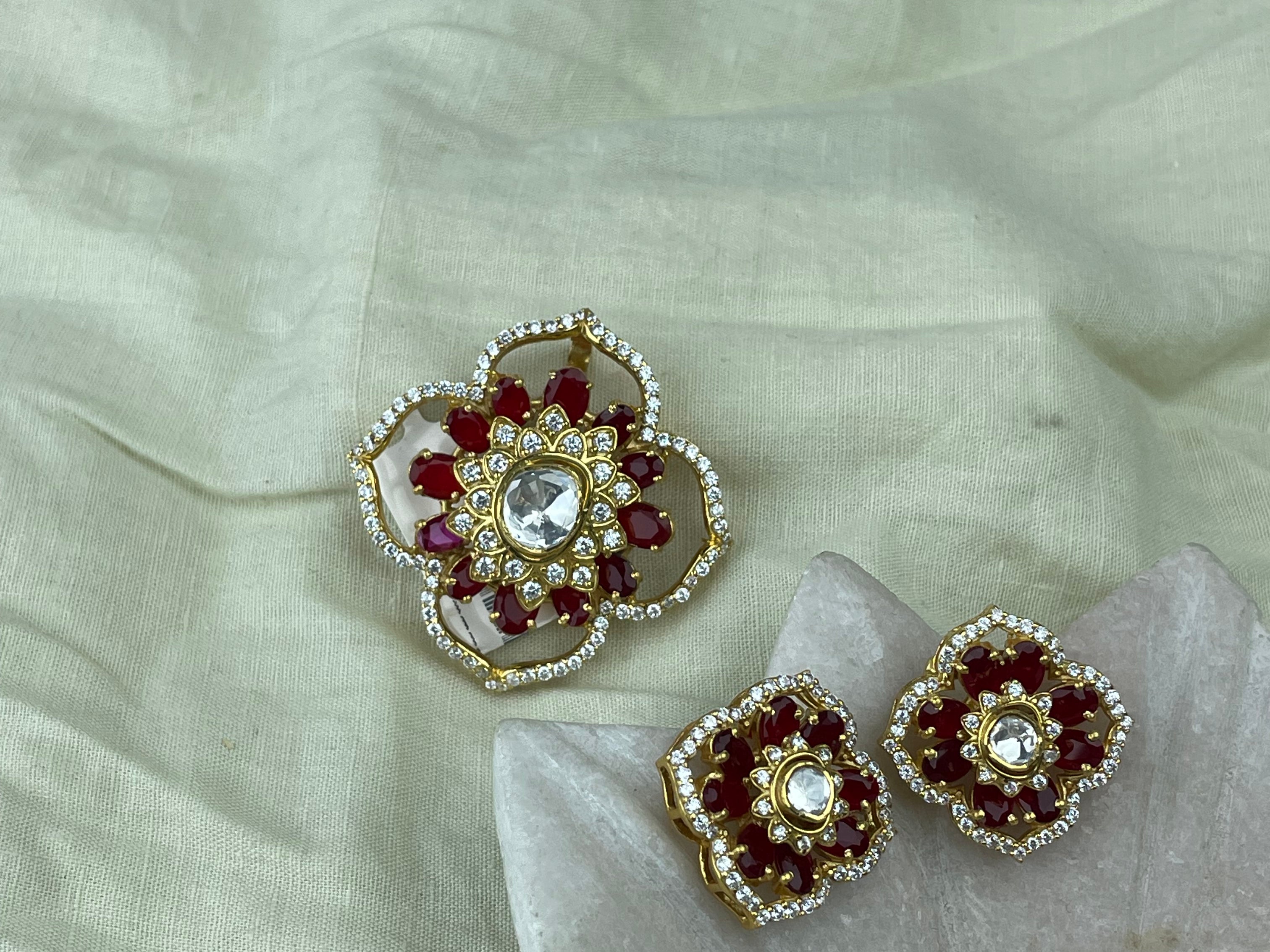 Pendant Set with matching a pair of gold-toned floral stud earrings.