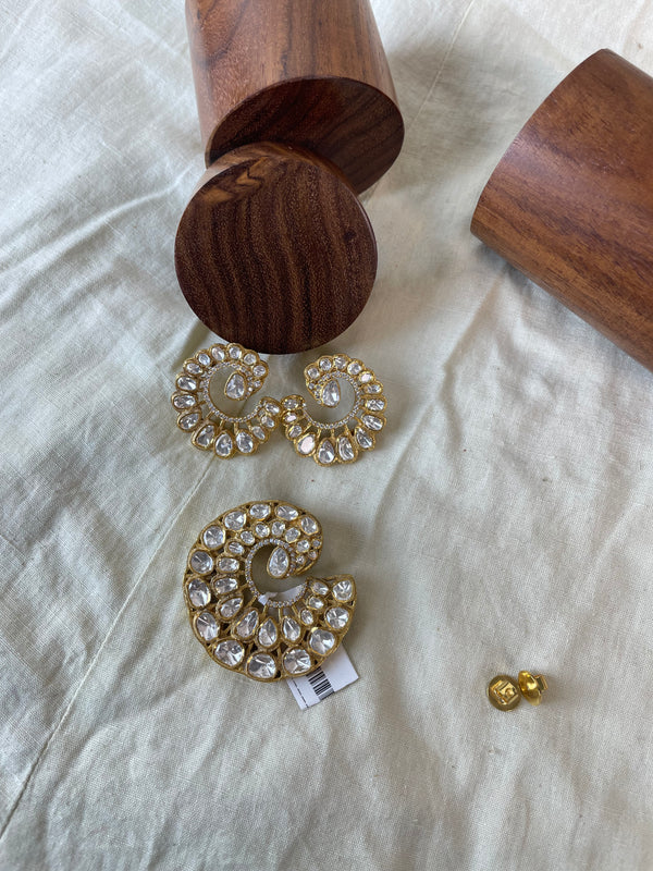 Chakravi Pendant Set with a bold circular pendant, layered clear stones, and gold-toned detailing.
