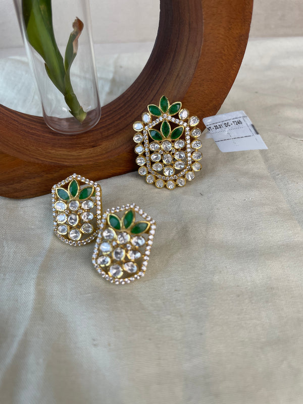 Pallavika Pendant Set with green floral stones, clear stones, and gold-toned detailing.
