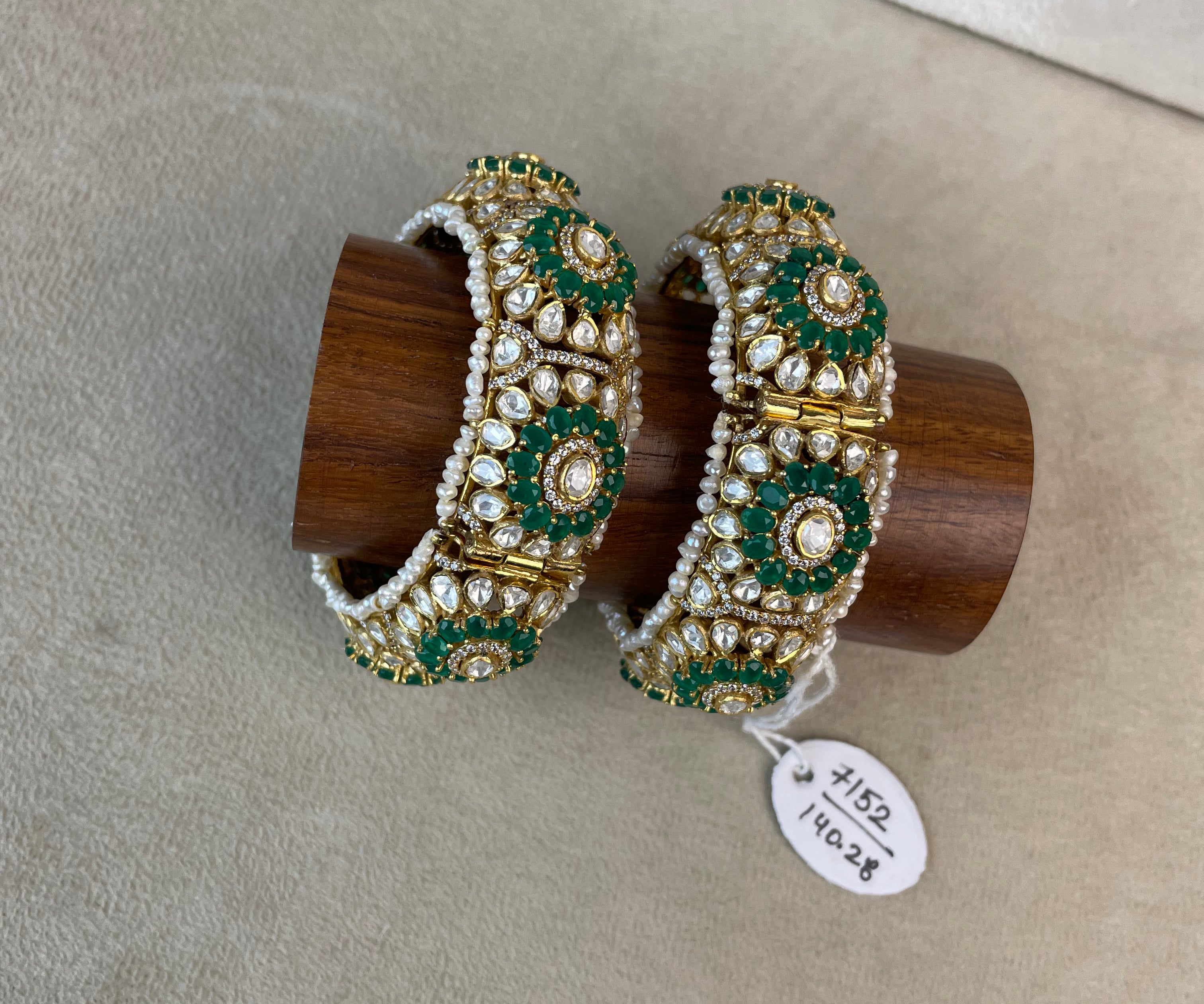 Pannali Bangles with green and white stone detailing and gold-toned floral design.