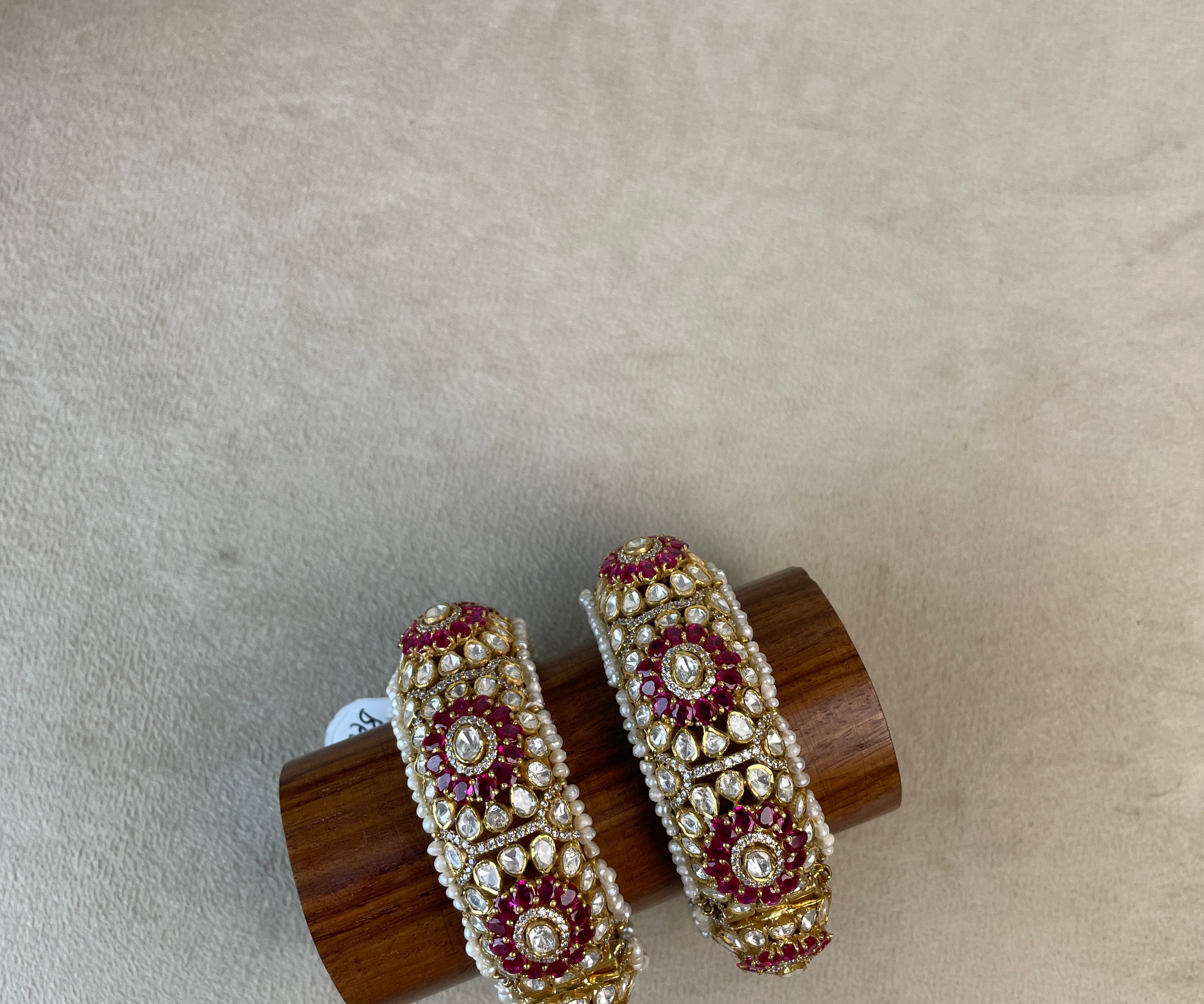 Rajraani Bangles with white stones, pink detailing, pearl borders, and a gold-toned floral design